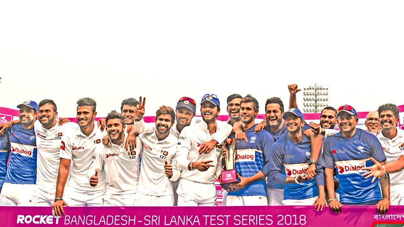 The Sri Lanka team poses with the series trophy after they won the second cricket Test against Bangladesh by 215 runs on the third day of the second Test to clinch the two-match series 1-0 at the Sher-e-Bangla national cricket stadium, Dhaka on Saturday. – AFP  