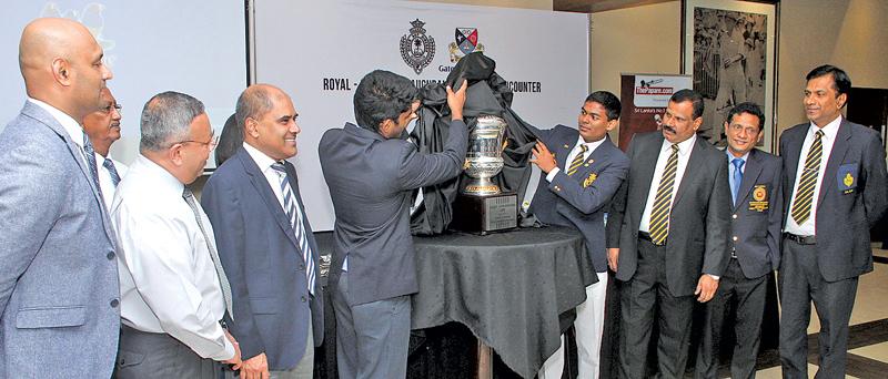 Captains of Royal College and Gateway Intl. College Tharindu Pasan and  Ishira Ritigahapola unveiling the Alles-Gunesekera Cup before handing it  over to the Principals of B.A. Abeyratne and Harsha K. Alles    
