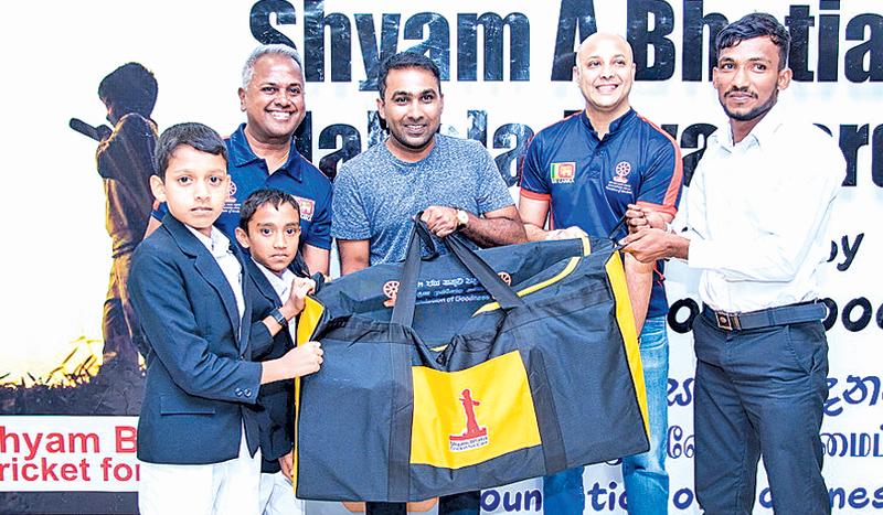 Former Sri Lanka captain Mahela Jayawardene, Ashan Malalasekera and Kushil  Gunasekera present cricket equipment bags to rural children. 