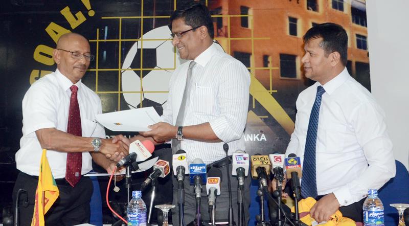Newly appointed Sri Lanka National football coach Nizam Rumy Packeer Ali receiving the appointment letter from FFSL President Anura de Silva. Also in the picture is Usmar Umar, General Secretary