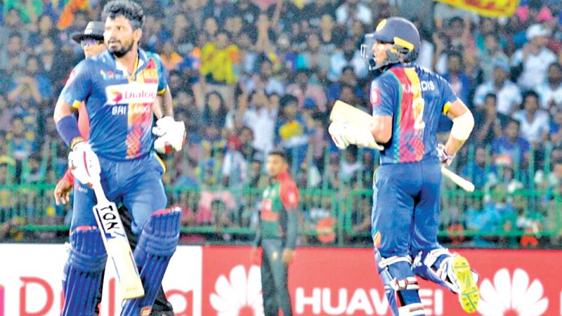 Kusal Perera and Kusal Mendis batting during their 85 runs partnership for the second wicket in the Hero Nidahas T20 match against Bangladesh at the R Premadasa Stadium yesterday. (Pic by SAMAN MENDIS)