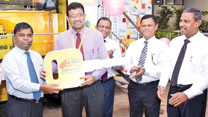 The Bank’s General Manager D.M. Gunasekera presents the vehicles to  Assistant General Manager Sabaragamuwa Province H.M.M.B. Herath. 
