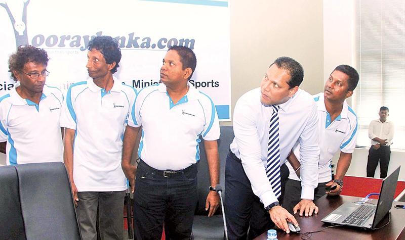 Sports Minister Dayasiri Jayasekera commissions the new sports website hooraylanka.com at a ceremony watched by its promoters Sanjaya Dissanayake (right) and Seevali Ediriweera (second from left). Others in the picture are Pulasthi Ediriweera and Kosala Perera   