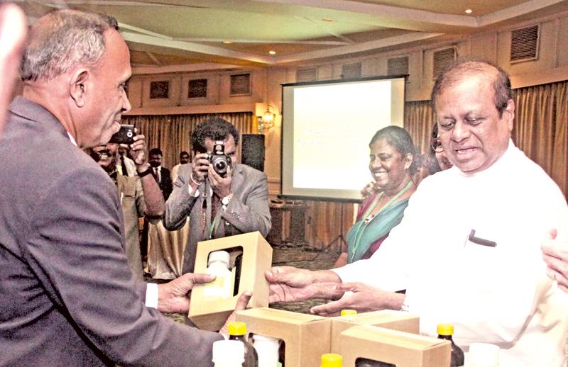 Pic: Chaminda Niroshana Minister Susil Premajayantha receives the product.