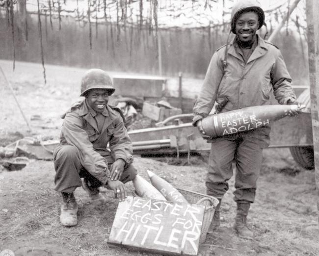 US soldiers of 969th Field Artillery Battalion decorate shells they’re delivering to front line in Germany, 1944