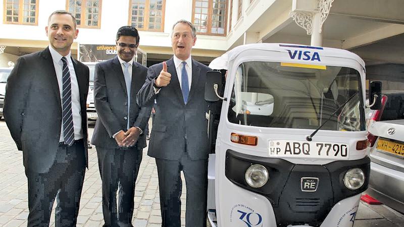 Visa officials with one of the 30 three-wheelers used in the promotional campaign   