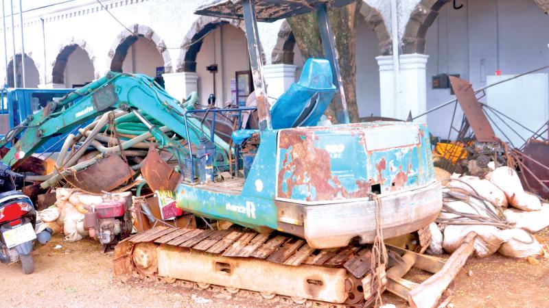 Backhoes and other confiscated equipment at the NGJA regional office, Ratnapura