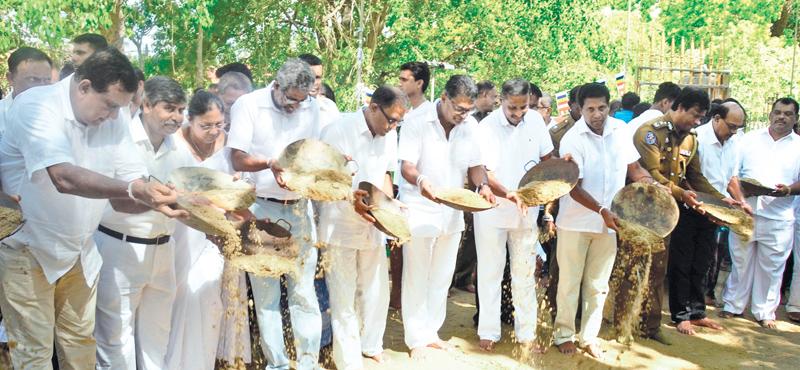  The Bank’s Board of Director member Ranel T. Wijesinha and CEO/General Manager Senarath Bandara (Center) strewing sand at the ceremony. Deputy General Manager Sales and Channel Management C. Amarasingha, Head of IT M.M.L. Perera, AGM NCP Ranjith Welikannage, AGM Province Sales Management E.M. Jayaratne, AGM Marketing Priyal Silva and AGM Brand Credit Range I- Tamara Perera are also in the picture.  