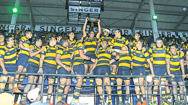 The Royal College team celebrate with the Bradby Shield after beating Trinity