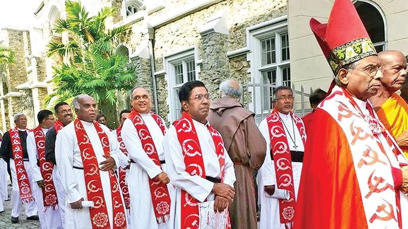 The Anglican clergy sporting red shawls with bold prints of the hammer and sickle