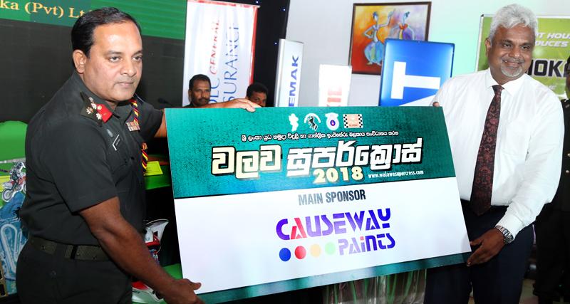 Colonel MAAD Sirinaga (left) accepts a sponsorship from Nirmal Hettiarachchie the Sales Manager of Causeway Paints in connection with the Walawa Super Cross  Picture by Tilak Perera