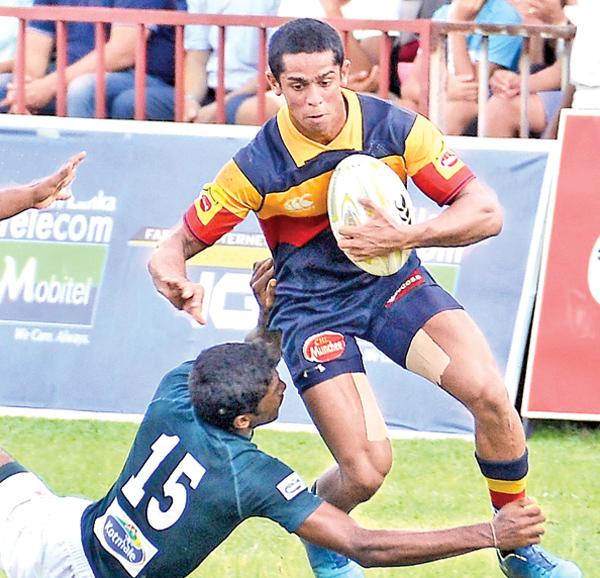 Trinity College player Sakalasuriya makes a break against the Isipathana College defence   Pic: Saman Mendis