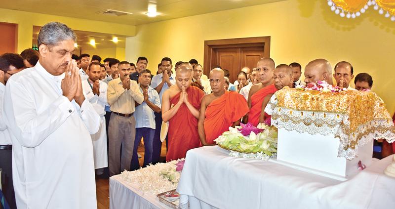 Minister Sarath Fonseka pays homage at the BMICH