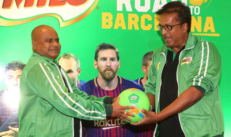 Vice President Nestle Lanka Norman Kannangara hands over a football to the Secretary to the Ministry of Education Sunil Hettiarachchi to mark the introduction of the under-12 schools football tournament named as the Road to Barcelona   