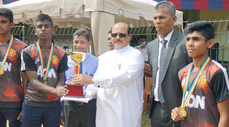  K Bandara the captain of the Under-16 boys champions Wickremabahu, receiving the Trophy from the Chief Minister Sarath Ekanayake as Director of Physical Education Athula Jayawardena looks on