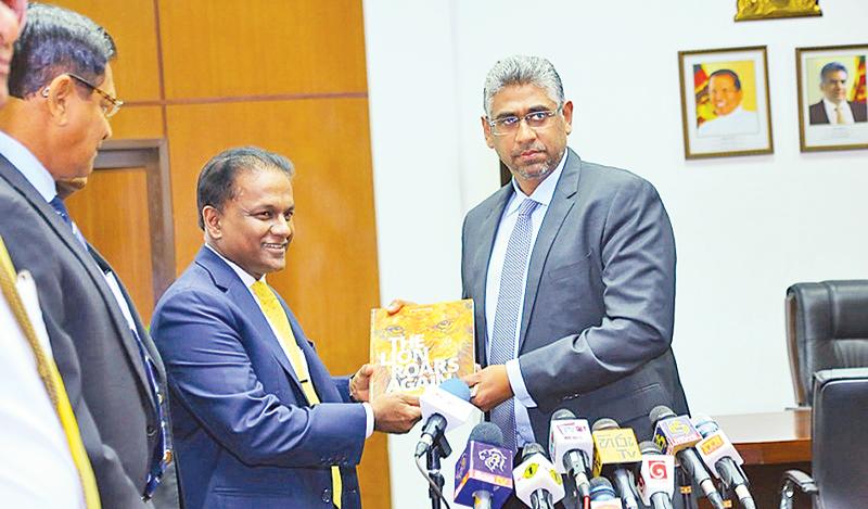 Sri Lanka Cricket president Thilanga Sumathipala (left) presents his annual accounts statement to Sports Minister Faizer Mushtapha at his ministry