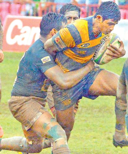 A Royal player attempts to break through an   Isipathana tackle
