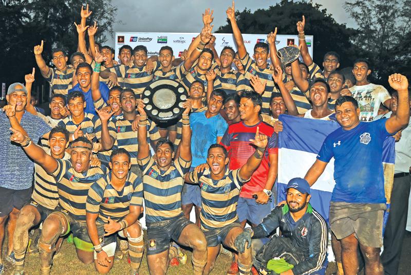 St. Joseph’s College players celebrate with the Fr. Basil Wiratunga trophy 