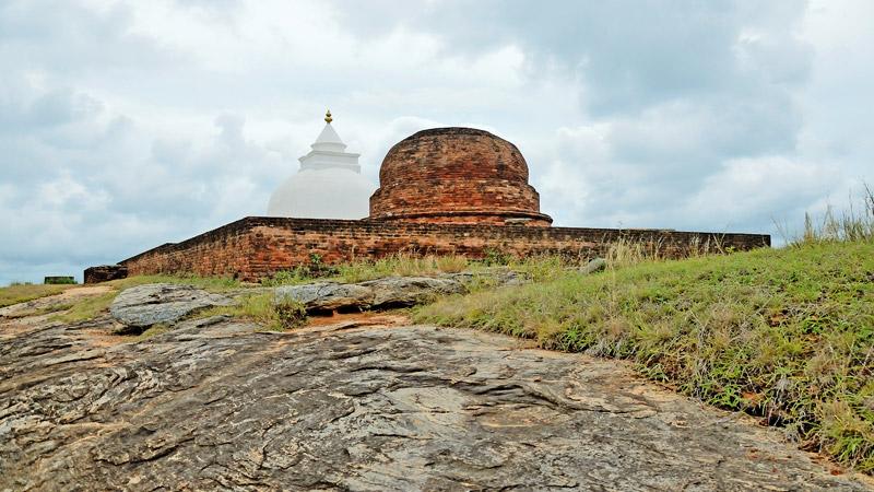   JEWEL OF BANDAGIRIYA: The newly renovated dagoba and age-old reddish brick dagoba remaining at the top of Bandagiriya rock boulder  