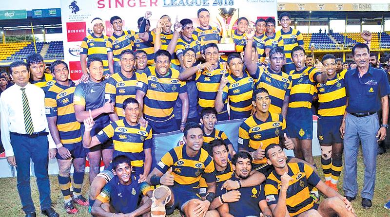 The champion Royal College rugby team celebrate with the Singer inter-school League title after beating St. Peter’s College 32-13