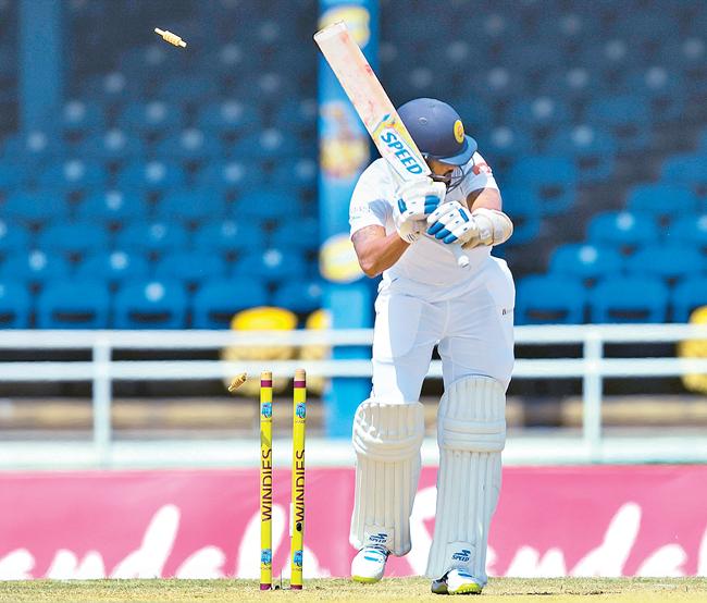 Sri Lanka batsman Roshen Silva is bowled on the third day of the first cricket Test against  the West Indies    