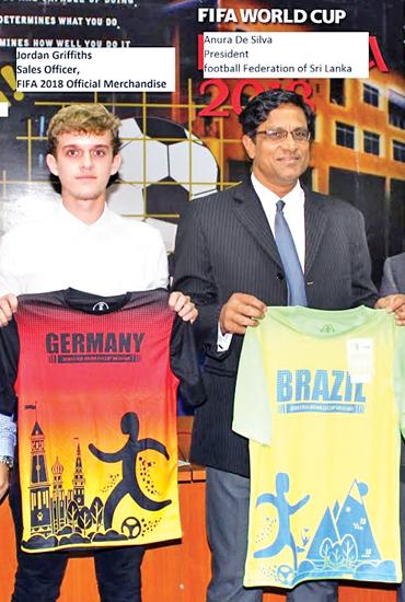 President of the Football Federation of Sri Lanka Anura de Silva (right) and FIFA licensed merchandiser Jordon Griffiths display the T-Shirts    