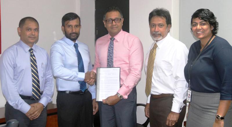 Managing Director, CL Synergy, Roshan Silva exchanges the agreement with  - Deputy CEO, DFCC Bank Thimal Perera. Also in the picture (from left): Finance Director, CL Synergy,  Janaka Udamulla, Director, CL Synergy, Rochana Jayawardana and Senior Manager, Payments and Cash Management, DFCC Bank, Sheron Mendis.    