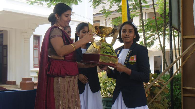 Maheshika Hewege the captain of the Mahamaya College swimming team receives the trophy from acting principal of the school Himali Senadheera