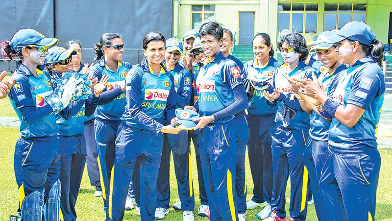 Sri Lanka women’s captain Shashikala Siriwardena presents Kaveesha Dilhari (right) with her cap (Pix courtesy papare)