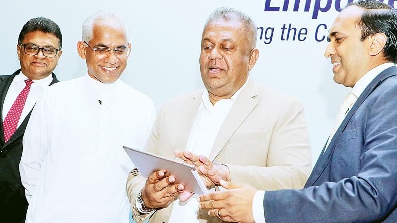 Finance Minister Mangala Samaraweera launches the SME Board at the SEC. State Minister Eran Wickremaratne, SEC Chairman Ranel Wijesinha and CEO Rajeeva Bandaranaike look on.  Pic: Saman Sri Wedage