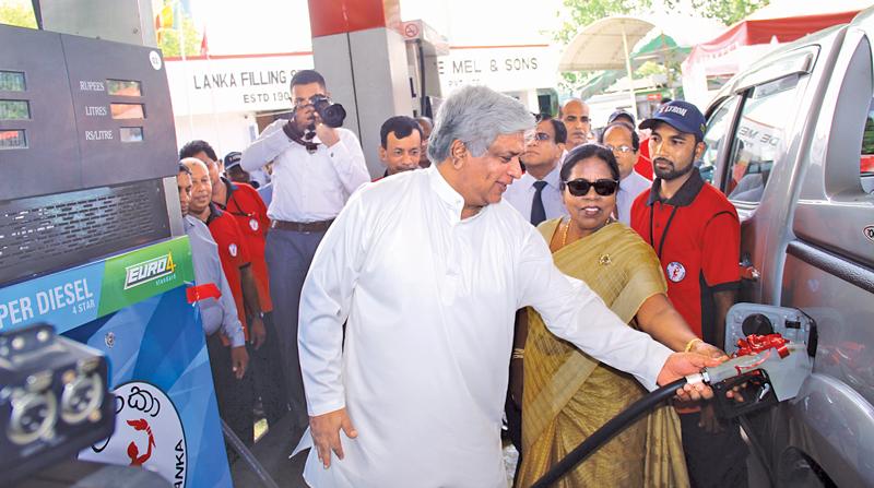Minister Arjuna Ranatunga dispenses Euro 4 fuel from the first Euro spec fuel dispenser at C.F. De Mel & Sons Filling Station in Colombo 2. Deputy Minister Anoma Gamage and CPC Chairman Dhammika Ranatunga were also present. Pic: Shan Rambukwella   