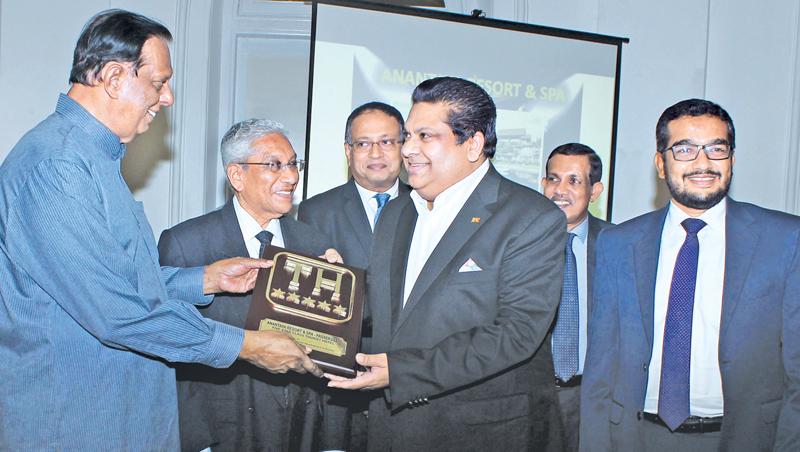 A hotelier receives a classification plaque from Minister Amaratunga.  Pic: Saliya Rupasinghe 