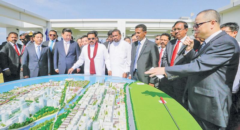 Sauce for the goose: Former President Mahinda Rajapaksa and Chinese President Xi Jingping inspecting a 3D model of the Colombo Port City in 2014 after inking the deal to build the brand new metropolis on land reclaimed from the ocean facing Galle Face, Colombo. The original agreement signed between Sri Lanka and China provided 20 hectares of free hold land in the newly reclaimed city to China Harbour Engineering Corporation, owned by the Chinese Government. The new Government renegotiated that contract and 
