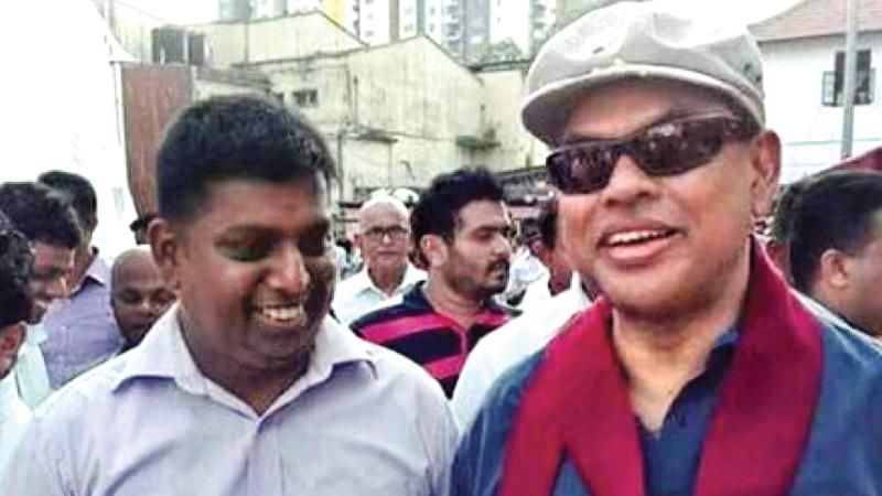 Railway  trade union leader Indika Dodangoda, one of the main  protagonists of the recent lightning train strike, pictured here with  SLPP strongman and former Minister Basil Rajapaksa  