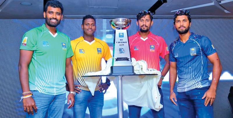 Captains all. From left: Thisara Perera (Dambulla), Angelo Mathews (Kandy), Suranga Lakmal (Galle) and Dinesh Chandimal (Colombo) pose with the lesser SLC T20 trophy they’ll play for    
