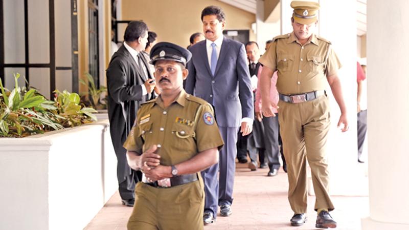 Former Chief of Staff to ex-President Mahinda Rajapaksa, Gamini Senerath being escorted to the Permanent High Court at Bar office, after he appeared before the newly opened Court on Friday, to finalise formalities before being released on bail.  Picture by  Chinthaka Kumarasinghe