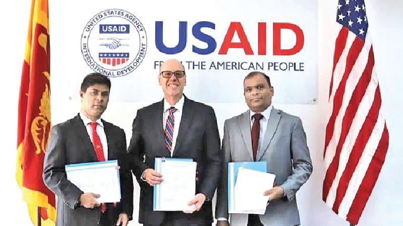 USAID Mission Director, Reed Aeschliman, with senior officials of Sampath Bank and Hatton National Bank following the launch of a partnership that provides local financing to MSMEs   