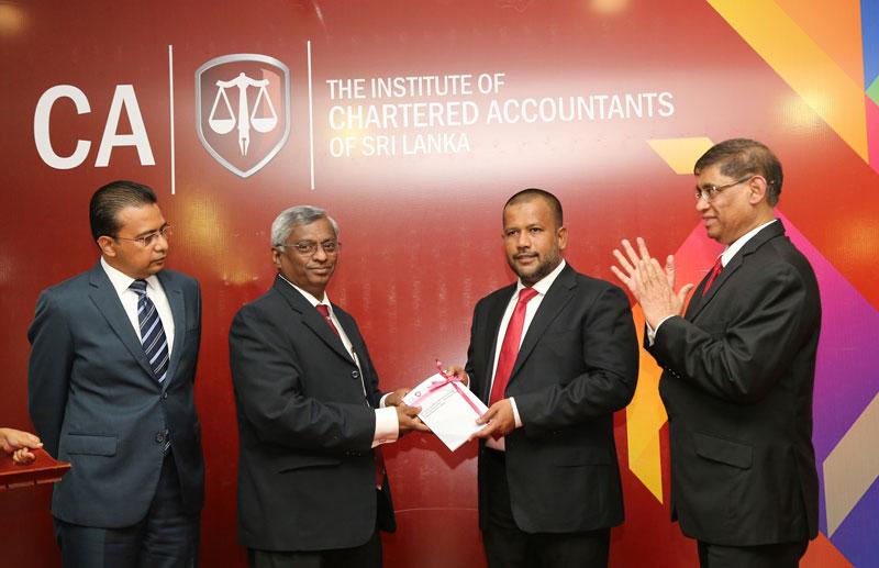 The first copy of the Standard being presented to Minister Bathiudeen by Lasantha Wickremasinghe. Jagath Perera and Sanath Fernando are also in the picture. 