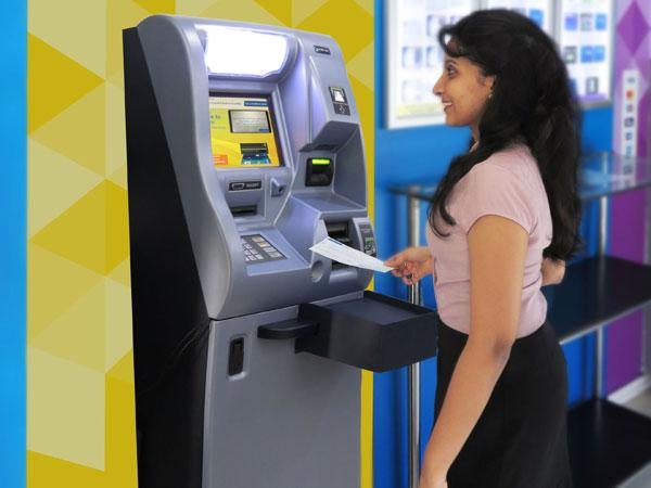 A depositor uses the fully-automated cheque deposit machine of Commercial Bank. 