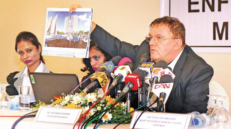 AGSEP Research CEO Dr. Dietmar Doering shows a model marina at the media briefing flanked by TJ Associates Managing Partner Dr. Tissa Jayaweera and other officials of AGSEP Research.    