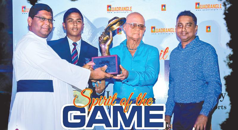 Rev. Fr. Henry Wijeyeratne (left) Principal of St. Anthony’s College Kandy receiving the Lorenz Pereira Trophy from Lorenz Pereira himself flanked by Sujith Silva, Editor in Chief of Quadrangle Magazine    