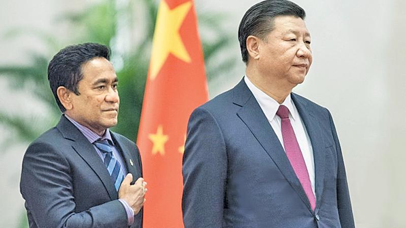 In this file photo taken on December 7, 2017 Maldives’ President Abdulla Yameen (L) and China’s President Xi Jinping listen to their national anthems during a welcome ceremony at the Great Hall of the People in Beijing. Back when he was a mild-mannered civil servant, few in the Maldives predicted Abdulla Yameen would one day run the country, let alone with an iron grip, locking up judges, his rivals and even his 80-year-old half-brother