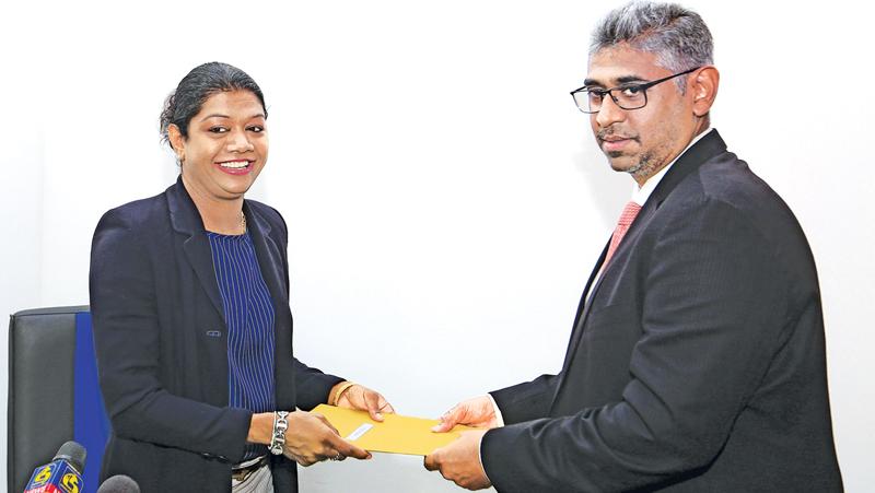 Susanthika Jayasinghe accepts her new appointment from Minister Faiszer Mushtapha