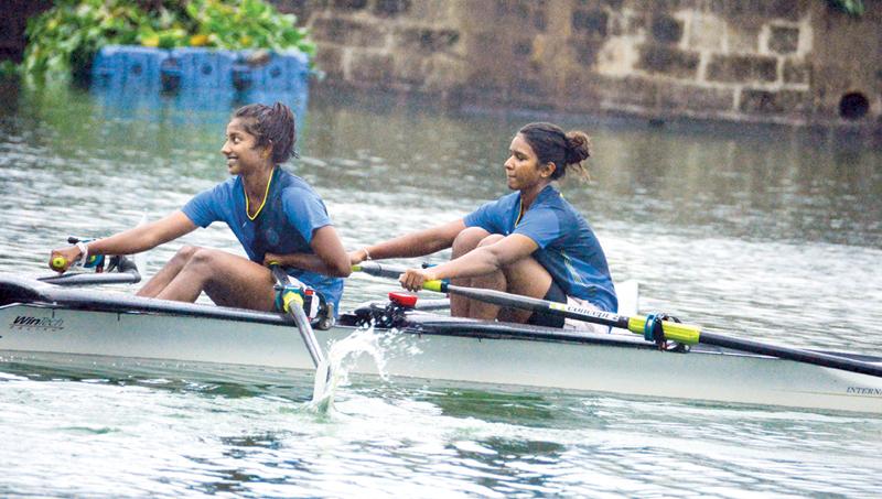 The ‘A’ Double Scull winning duo of Medhini de Alwis and Senuri de Silva from Musaeus College row to victory over Ladies College at their annual rowing meet on the Beira Lake yesterday