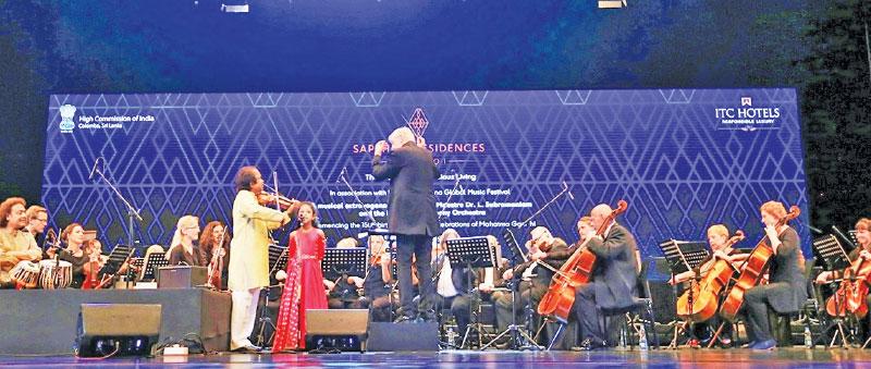 Dr. L. Subramaniam and his granddaughter Mahati Subramaniam along with the Liepājas Symphony Orchestra