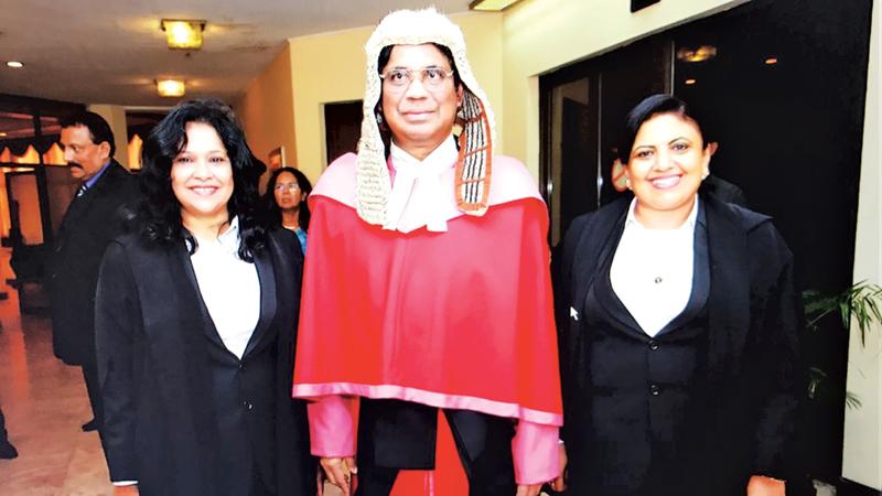 Members of the SLWLA sported the new lady lawyers’ attire during the ceremonial farewell for the former CJ as an appreciation for approving the new attire. Seen here are the President and Secretary of SLWLA with the former CJ. 