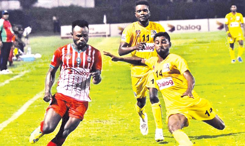 Super Sun’s Mohamed Fahim (right) and New Youngs player BS Nimo vie for the ball in their Dialog Champions League football match at the Durayappa Stadium in Jaffna   