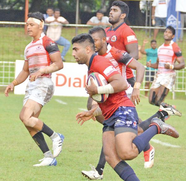 CR’s play-maker Tharinda Ratwatte makes a break to cross the line and score Pic: Thilak Perera    