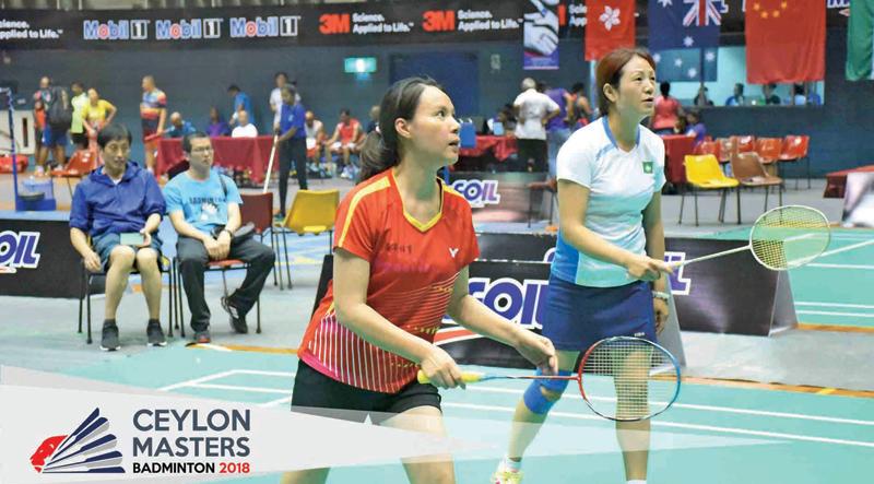 Two Chinese women confronting two Indian women in the 45+ doubles match