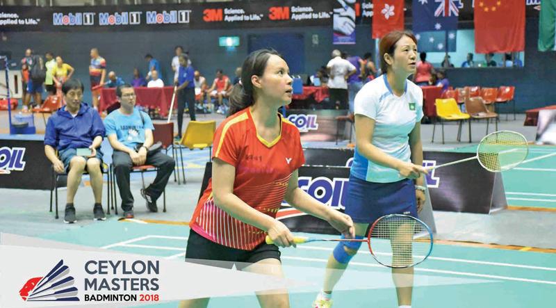 Two Chinese women confronting two Indian women  in the 45+ doubles match  